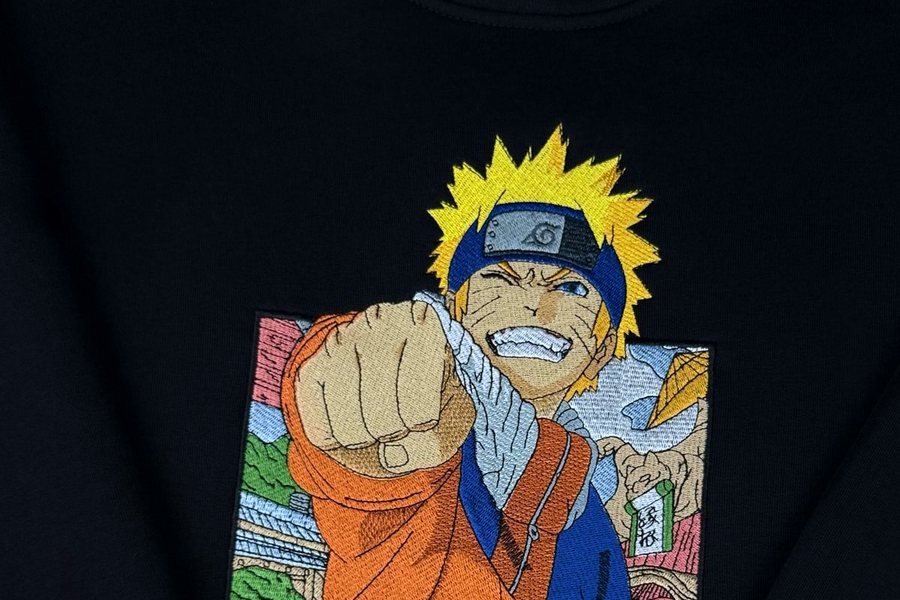 Navy hoodie with a large full-colour embroidered character panel on the chest